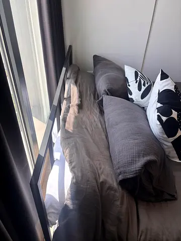 Bed with black metal frame and mattress