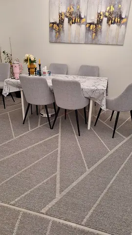 Dining table with 6 grey upholstered chairs and rug