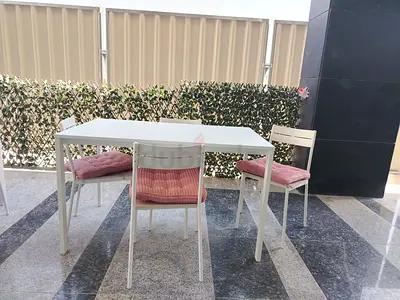 White Outdoor Dining Table with 4 Chairs and Cushions