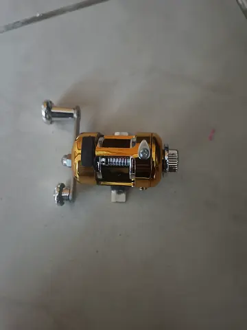 Used Gold Baitcasting Fishing Reel - Compact and Functional