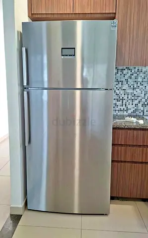 Silver double-door refrigerator, good condition, 2-door top freezer series 8  model free home delive