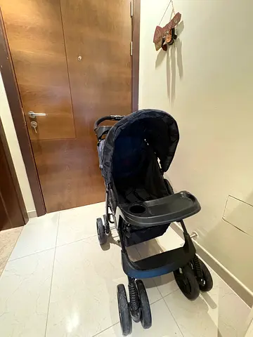 Used navy single-seat baby stroller with tray and storage