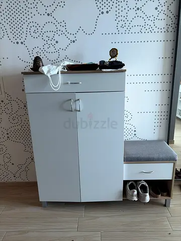 white shoe storage and cushioned bench
