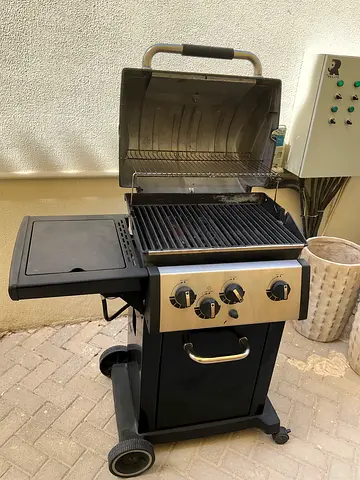 3-burner gas BBQ grill on cart with side shelf