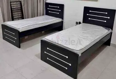 Brand New Pair of single beds with mattresses - simple black wooden frames