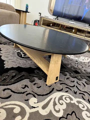 Round Coffee Table with Black Top and Light Wood Legs
