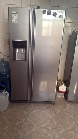 Large stainless steel side-by-side refrigerator with water dispenser