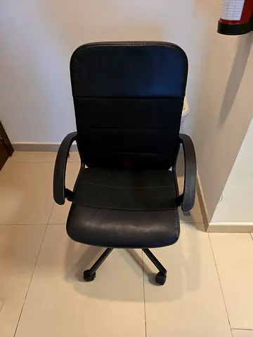 Black ergonomic office chair with armrests and wheels