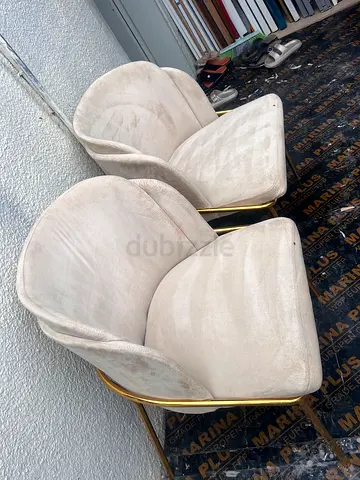 Pair of modern beige velvet lounge chairs with gold frame