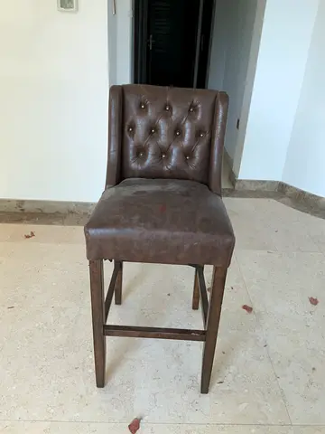 Leather-topped brown chair sturdy wooden legs