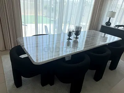 Modern rectangular marble-top dining table with 8 black boucle chairs