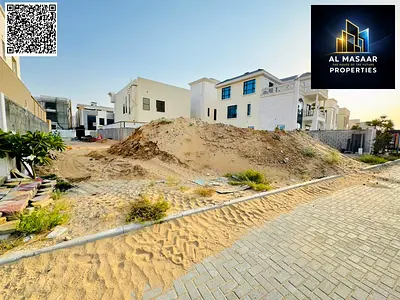 Prime residential land for sale in Al Alia area – Ajman. Strategic location on an asphalt road. Land area: 5,920 sq ft. Building permit: Two floors an