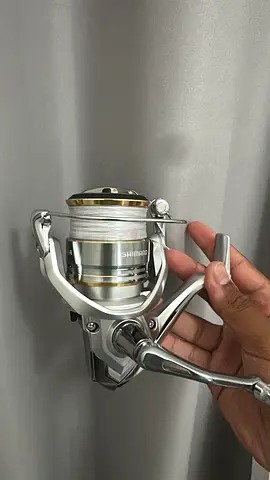 Shimano spinning fishing reel with line - good working condition
