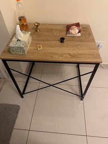 Small wooden side table with metal X-frame legs
