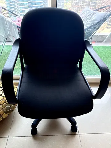 Black ergonomic office chair with armrests and wheels