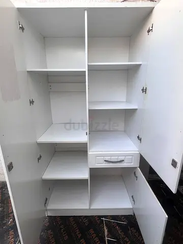 White multi-compartment storage cabinet with shelves and drawers