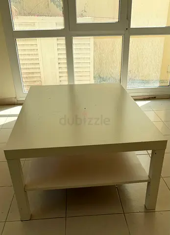 Simple white rectangular coffee table with lower shelf