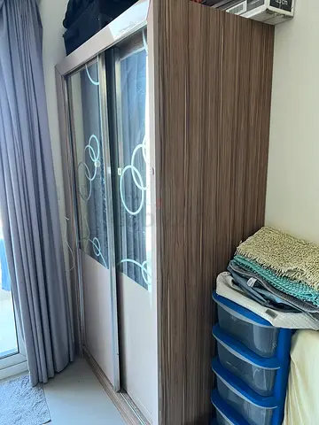 Two-door sliding wardrobe in wood finish with mirrored panels