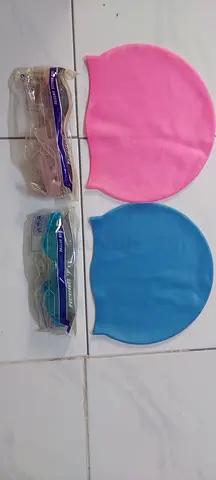 Two silicone swim caps (pink + blue) with goggles