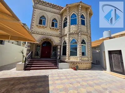 Villa for sale in Ajman, Al Rawda area. It consists of 5 master bedrooms, a majlis (formal sitting room), a living room, a maid's room, and an externa
