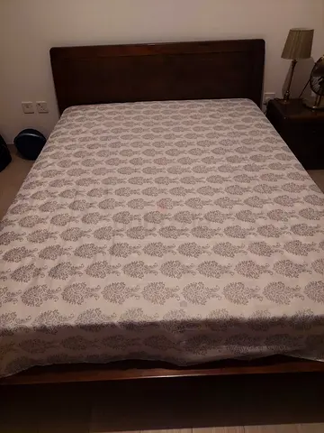 Double bed with mattress and bedside table