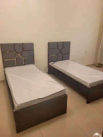 Two single beds with upholstered headboards — good condition