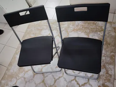 Set of 2 Black Folding Chairs with Metal Frame and modern area rug Good Condition