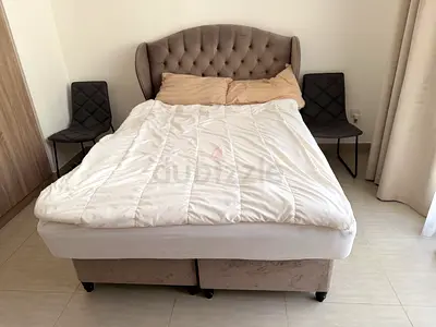 Large double upholstered bed with storage base and IKEA mattress — good condition