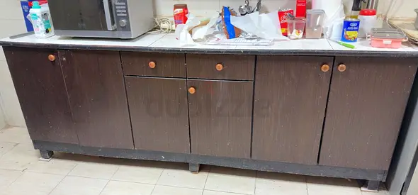 Long dark wood kitchen base cabinet with countertop