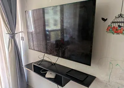 55-inch Smart LED TV mounted with wall shelf (working condition)