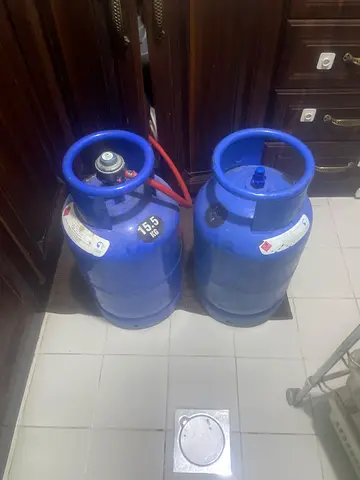 Two blue LPG gas cylinders - 15.5kg  (Full unused) and 15.5kg (used)