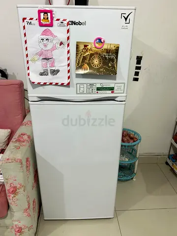 Compact double-door refrigerator in best working condition, with minimum usage.