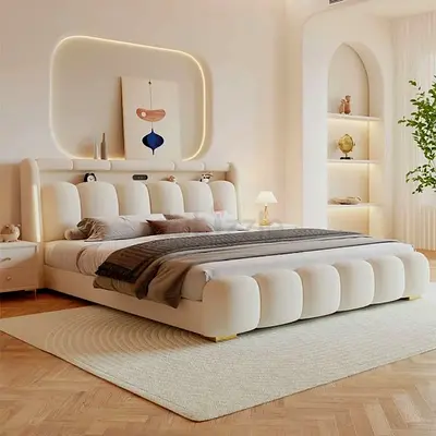 Modern upholstered king-size bed with padded headboard in cream