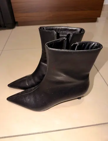 Black pointed-toe mid-calf heeled boots - size not specified