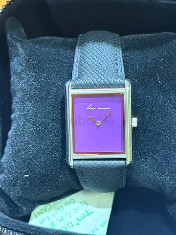 Simple rectangular womens wristwatch with purple dial and black leather strap