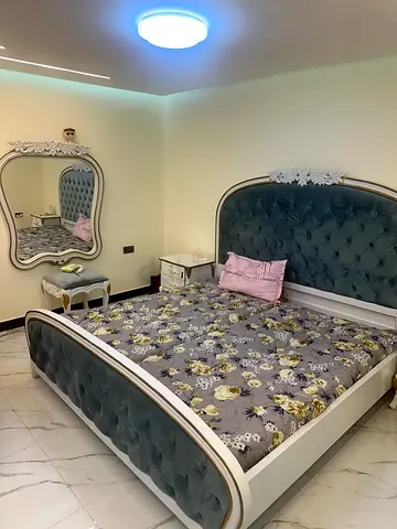 Queen upholstered bed frame with tufted headboard and footboard