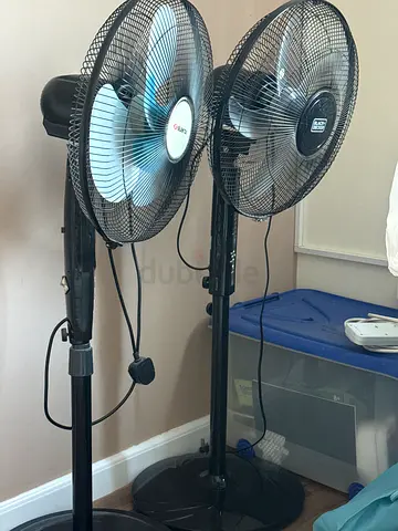 Two black standing oscillating fans - good working condition