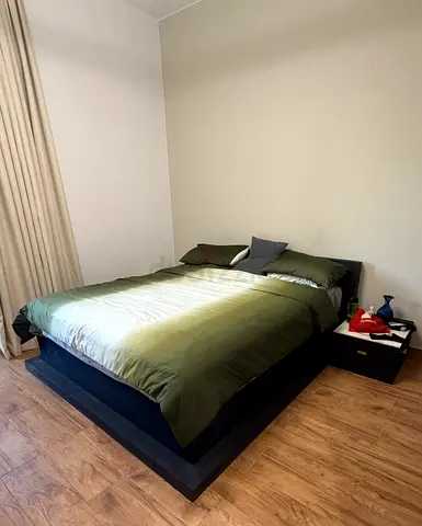 Modern low platform queen bed with headboard and bedside table