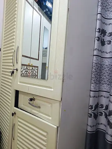 Used cream-colored wardrobe with mirror and drawers - good condition