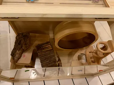 Wooden small pet habitat with exercise wheel and accessories - good condition perfect for hamster.