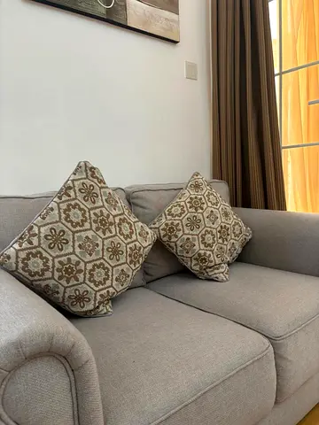 Light grey 2-seater sofa with patterned cushions - amazing condition