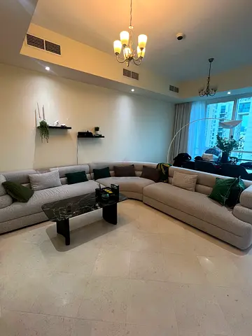 Curved light-grey sectional sofa in good condition