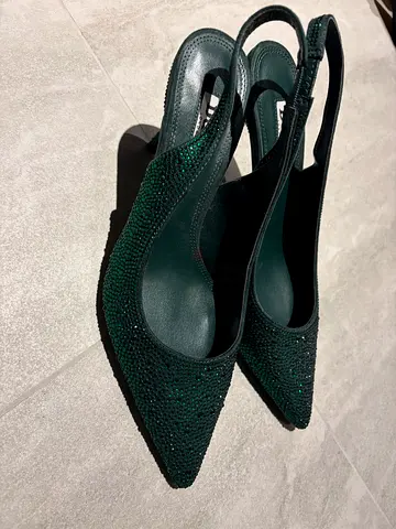 Emerald green slingback pointed heels with crystal embellishments
