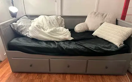 Grey wooden daybed with 3 storage drawers and 2 mattresses