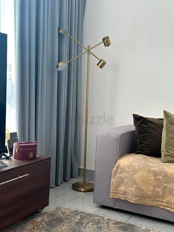 Modern brass floor lamp with three adjustable heads