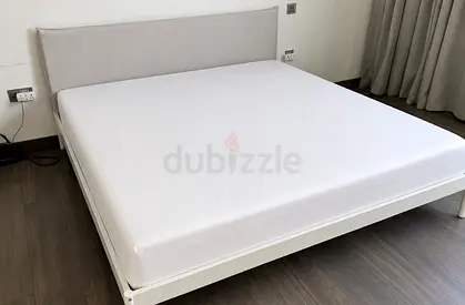 White double bed frame with headboard and mattress