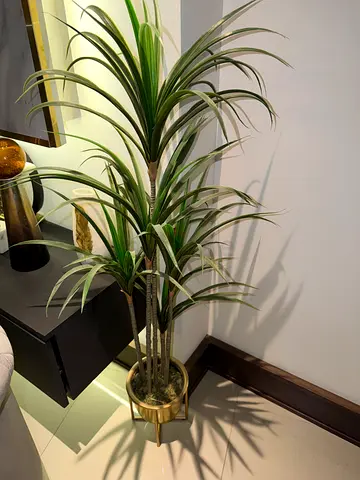 Tall artificial potted plant with decorative gold planter