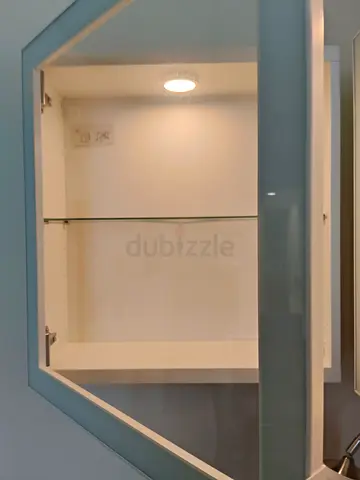 Wall cabinet with glass door, glass shelf and decorative light