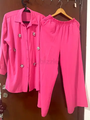Two piece pink matching set shirt and trousers
