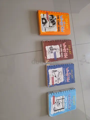 Set of 4 Diary of a Wimpy Kid paperback books (The Long Haul, The Third Wheel, Rodrick Rules)